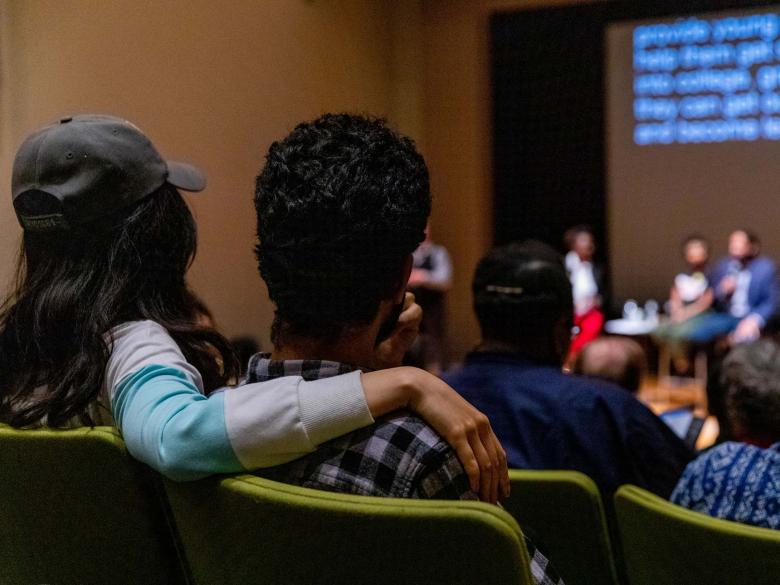 The backs of couple's heads, sitting in Remis Auditorium during lecture