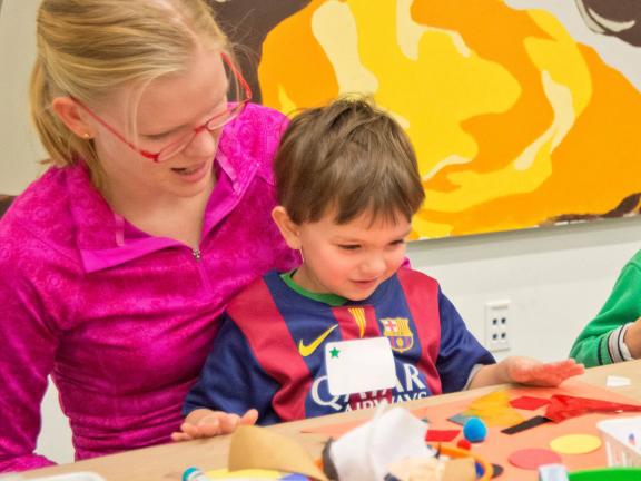 Mother and child making a collage artwork together. 