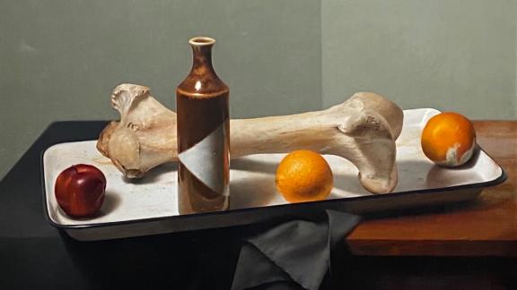 A still life painting of a white tray with a bone, oranges, an apple, and a bottle.