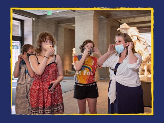 Four visitors putting on masks