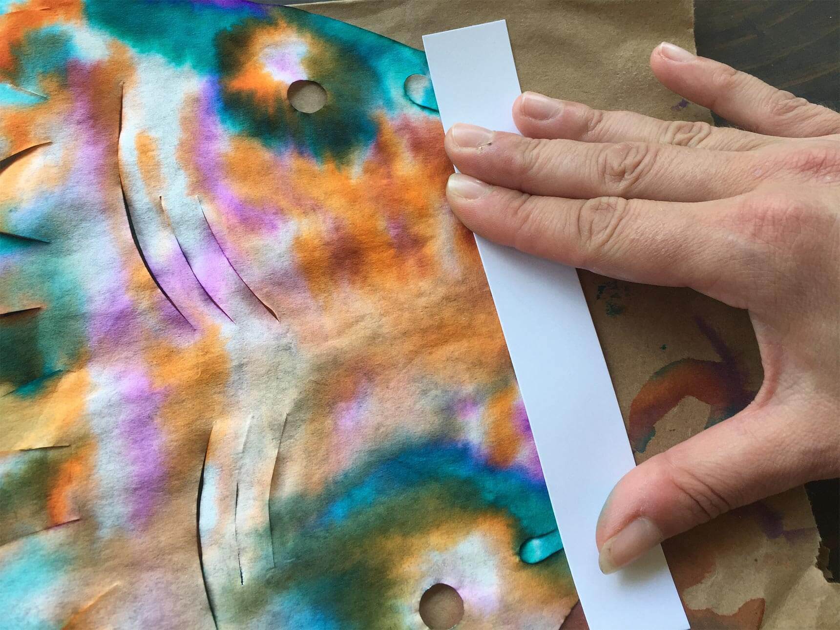 Gluing strip of card stock on mouth of fish template