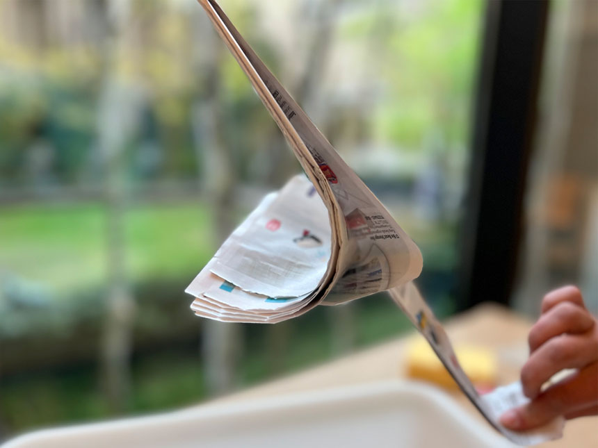 ripping pages from magazine into long strips