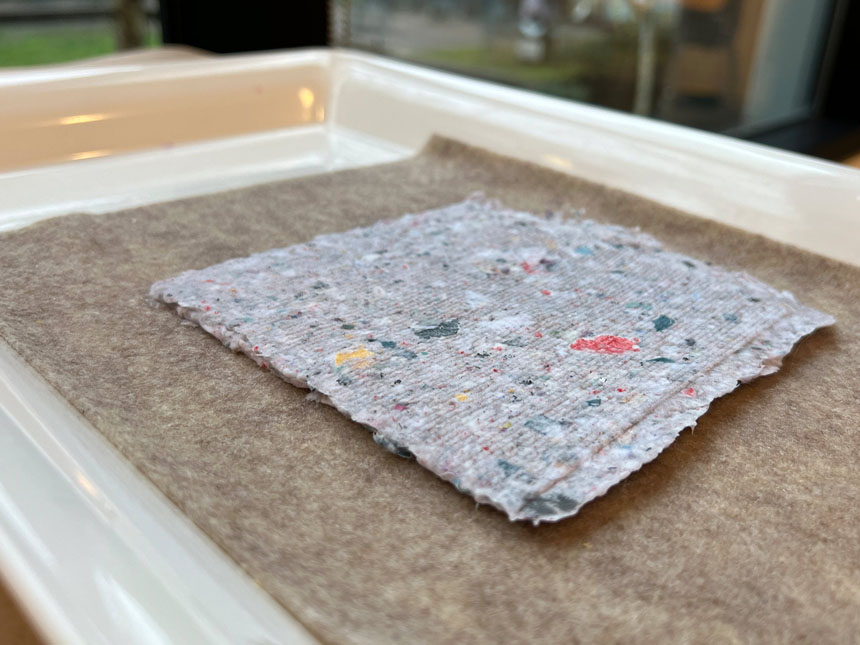 slab of paper pulp on top of felt sheet after mould removed