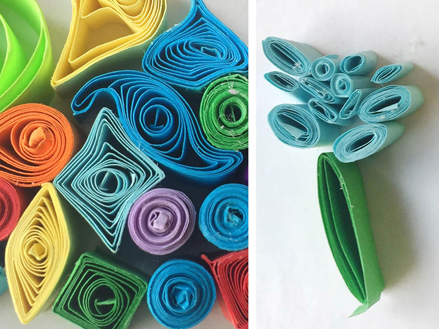 arrangement of quilled paper, all of different colors, rolled up to form different shapes