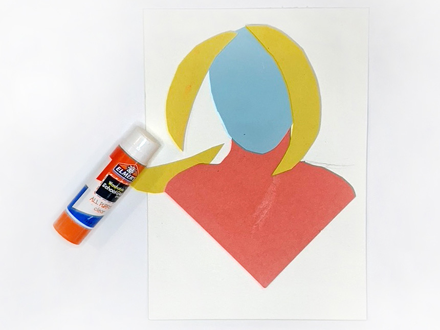 using glue stick to glue together cut-out shapes to form figure's head, hair, and chest