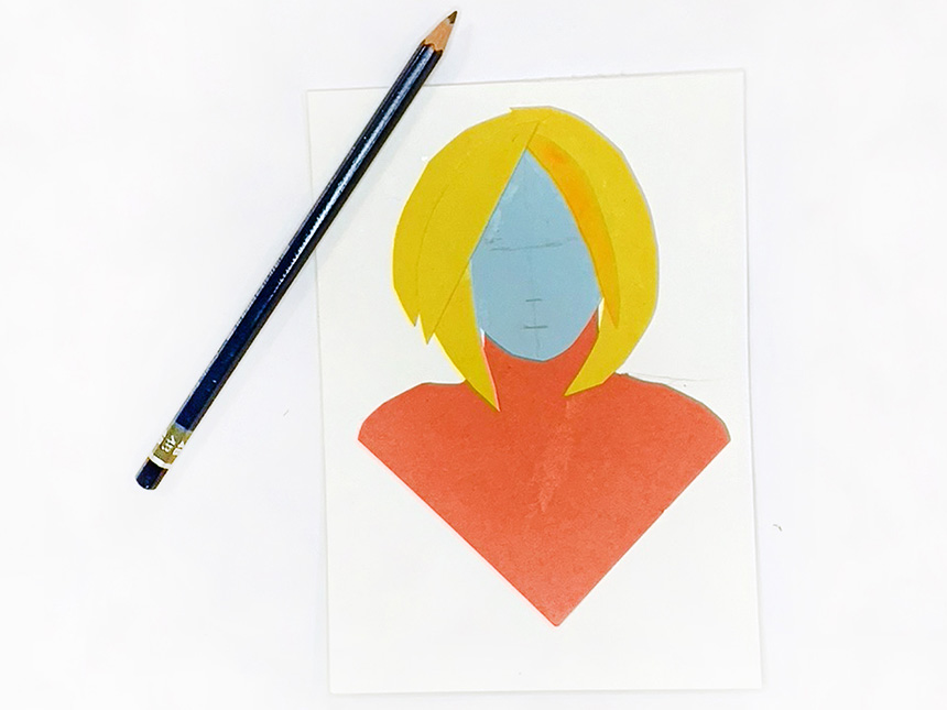 pencil markings drawn on face of glued-together arrangement of construction paper, forming figure's head