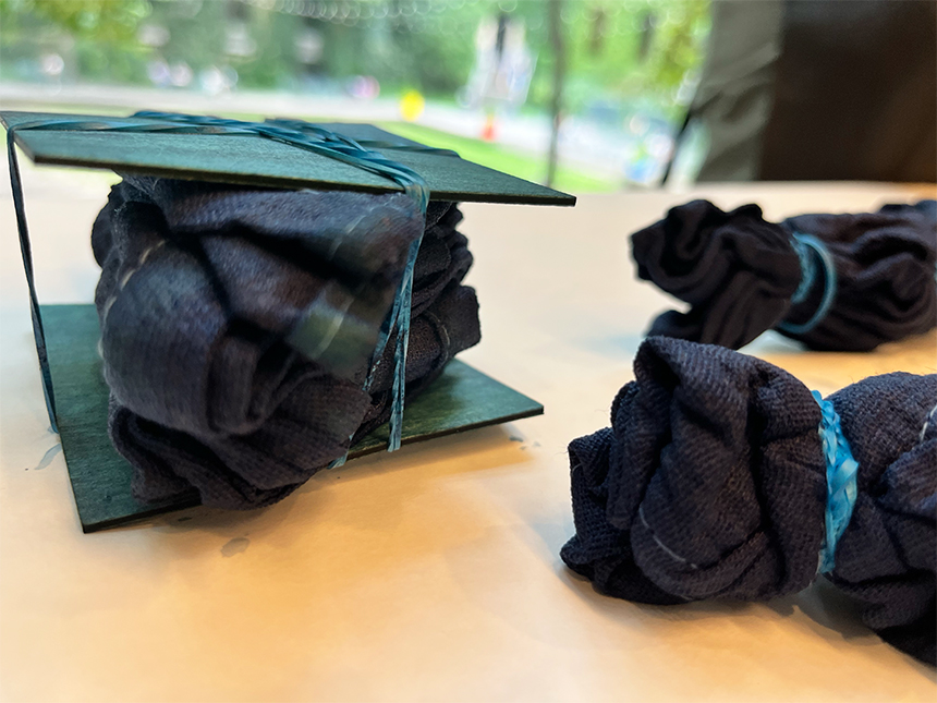 blue-dyed fabric bundles resting on tabletop
