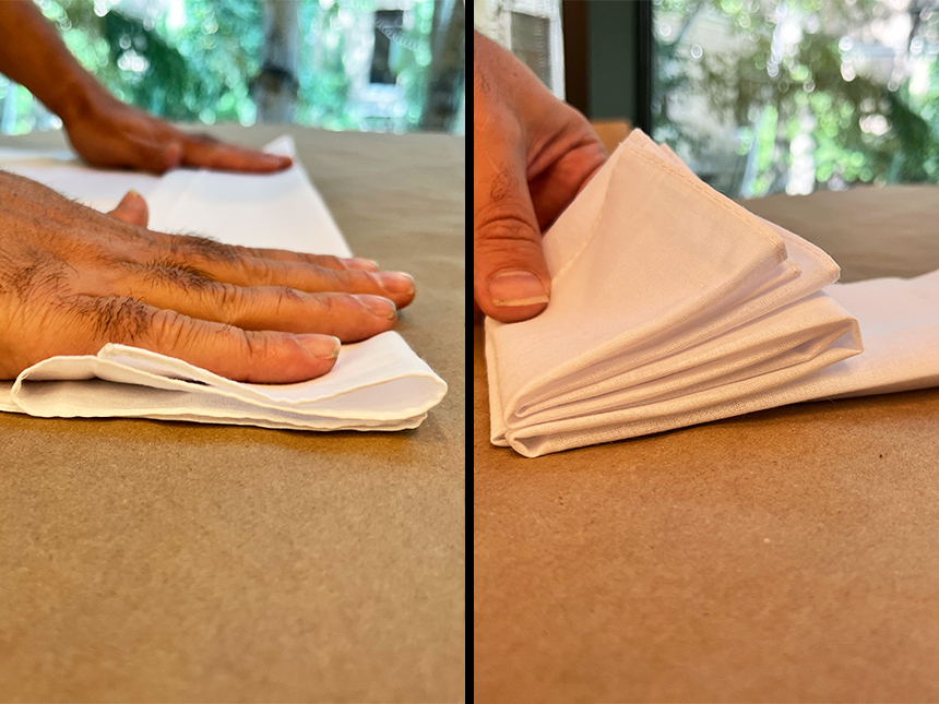 two photos side-by-side: on left, hands pushing down on linearly folded white cloth; on right, rectangle of folded cloth folded further into square shape