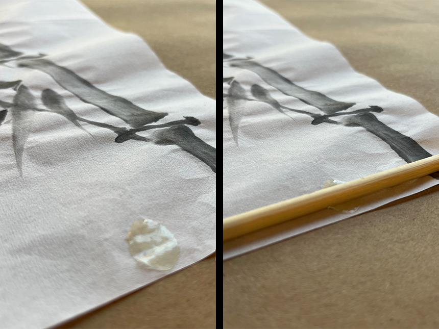 applying glue dot to back of rice paper and placing dowel on it