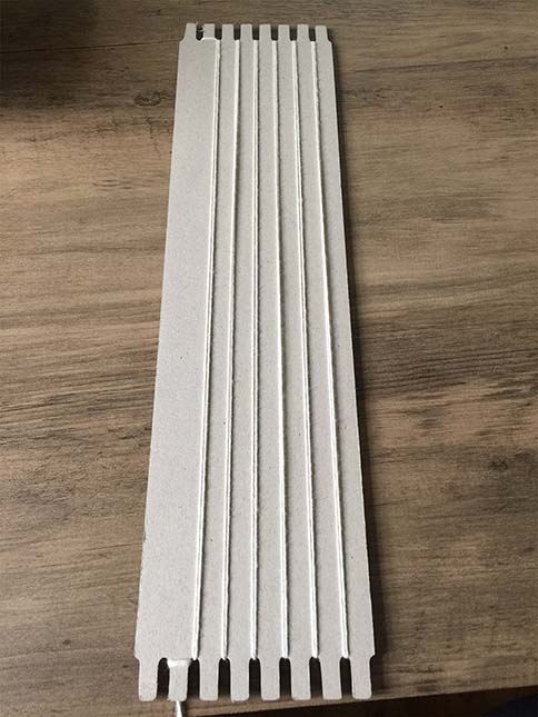 string wrapped around notches on cardboard loom