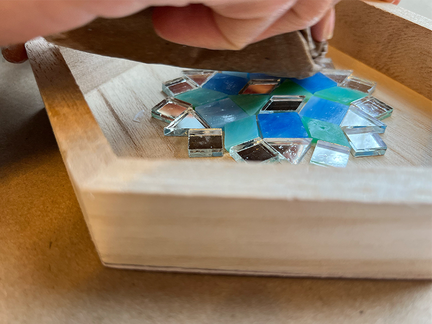 using cloth to wipe over glued tiles