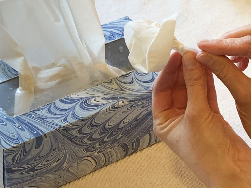 Tissue paper bunched and shaped like flowers, with tape used to bundle stems