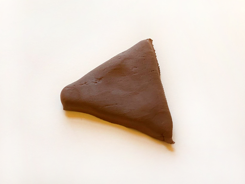 small triangle made of brown clay