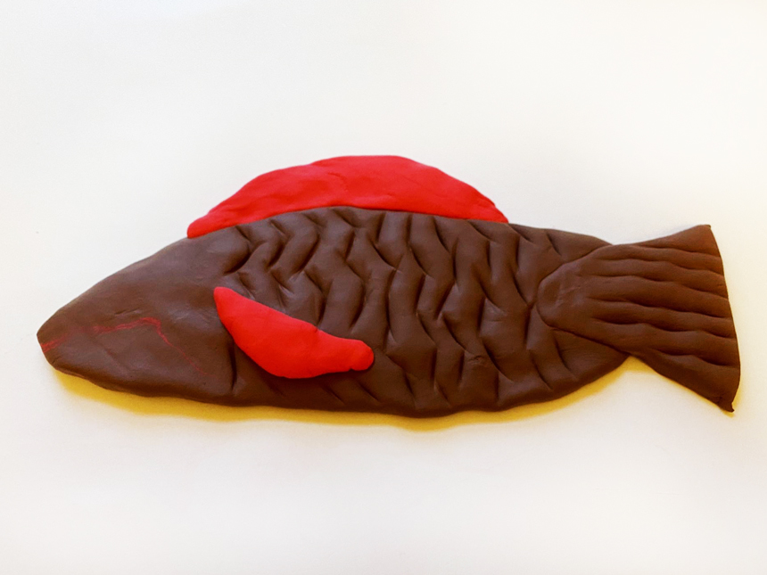 scales etched into clay fish body