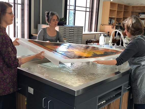 Removal of Chéret poster from water bath