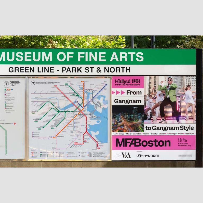 "Hallyu" ad next to MBTA subway map at Museum of Fine Arts stop
