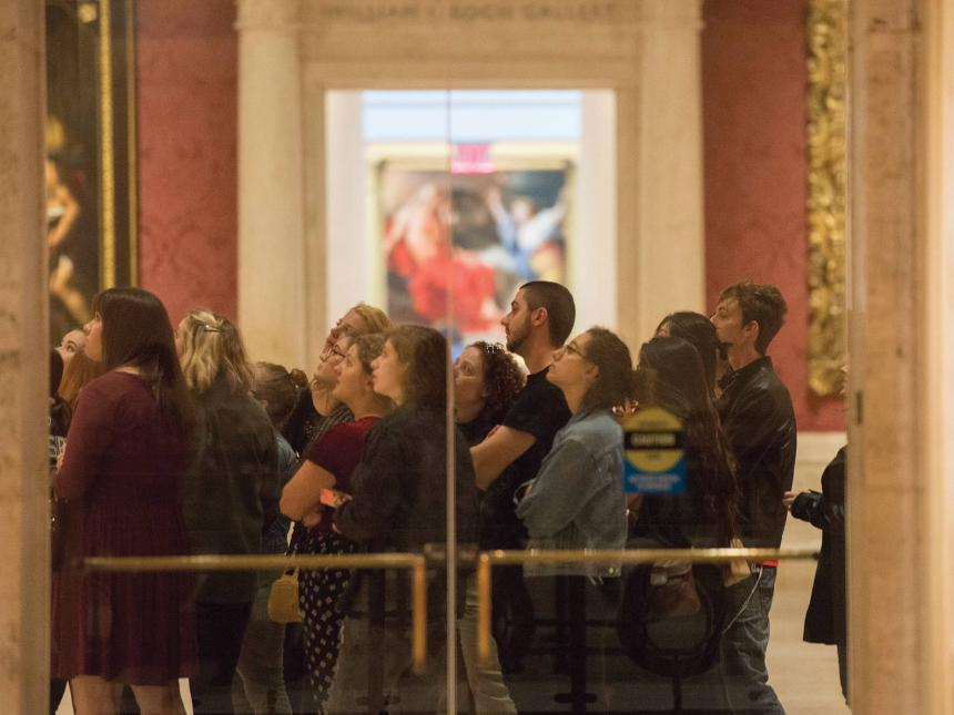 A group of visitors looks at a painting in the Koch gallery