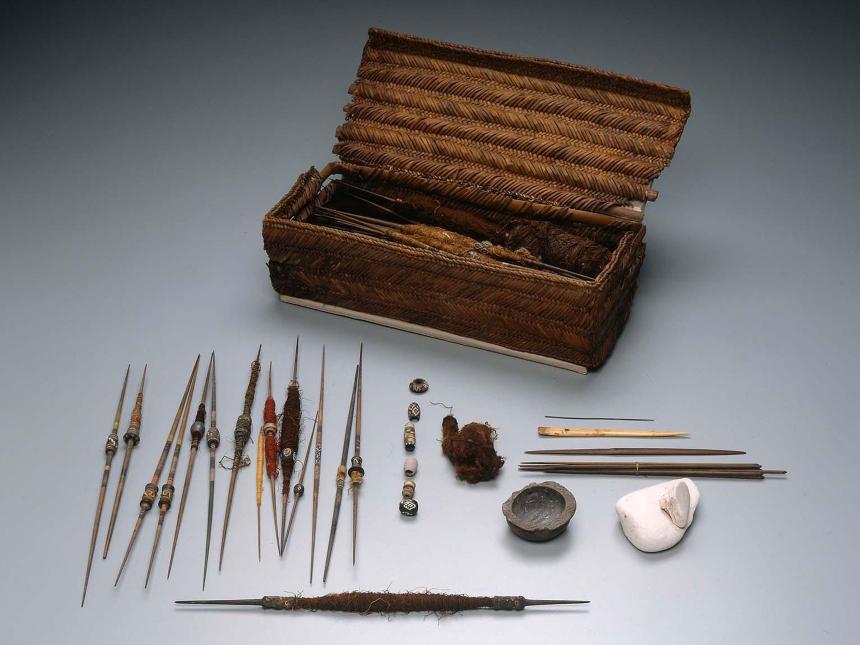 Peruvian weaver's workbasket displayed with a variety of spindles, picks, and bobbins