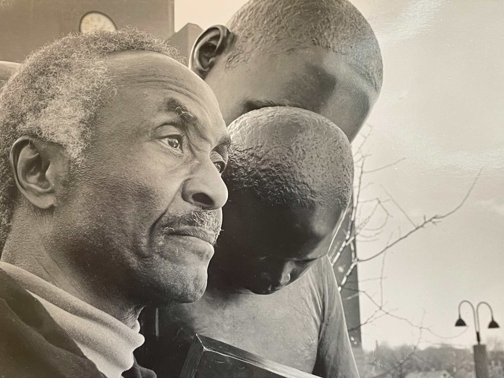John Wilson with his sculpture 'Father and Child Reading' at Roxbury Community College