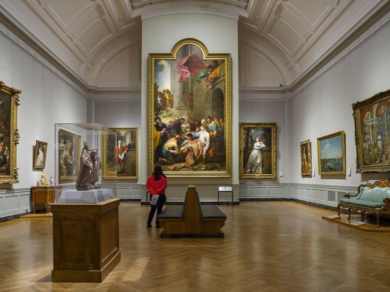 Visitor in Gallery 246, looking at Benjamin West's painting, Devout Men Taking the Body of Saint Stephen, at center