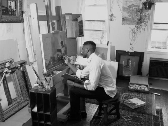 Artist Jas Knight working in studio, painting at easel