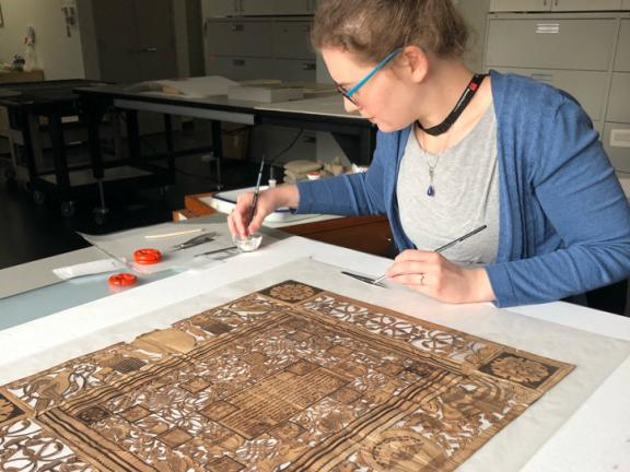 Conservator treating Judaica papercut