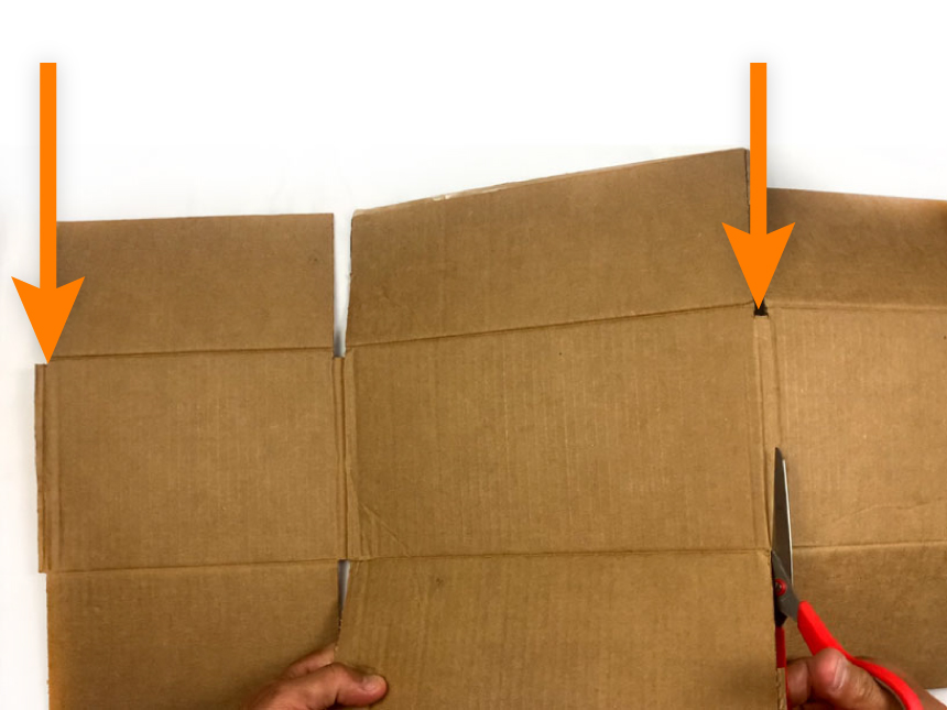 flattened cardboard box with arrows pointing to edges to cut