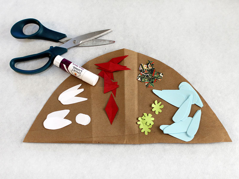 colored papers cut to various shapes laid on top of paper bag