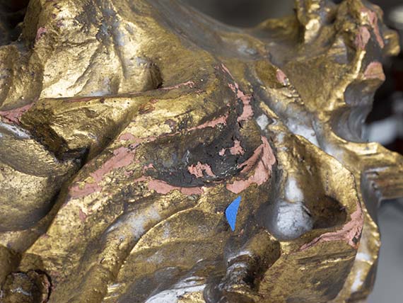 Detail of the Lion Rampant’s mane showing areas of flaking gilding and loss