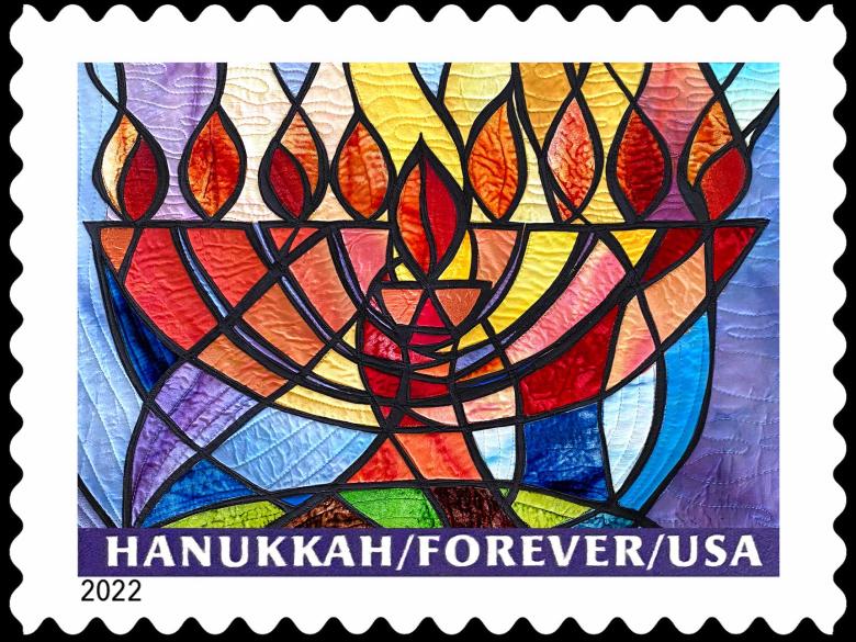 The Hanukkah Forever USA 2022 stamp of a colorful, silk menorah against a black background.