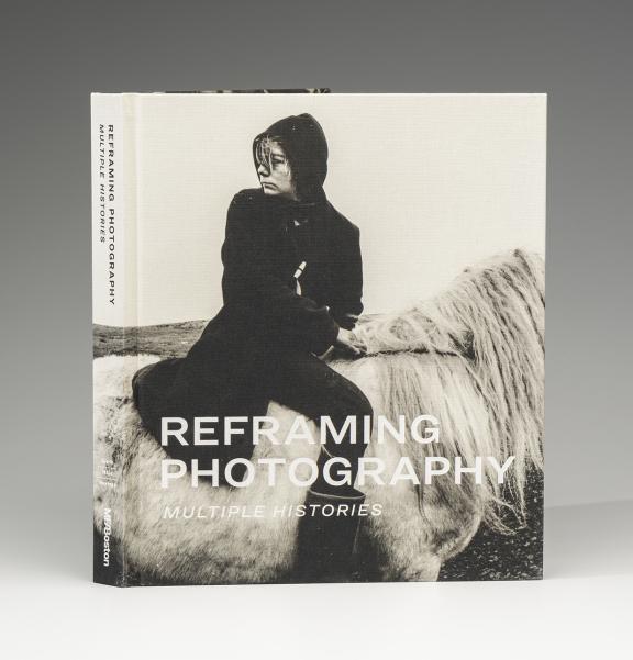 Book cover for Reframing Photography: Multiple Histories. A young person in black sitting on a white horse. They look over their shoulder.