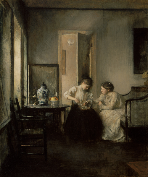 Two women sit in a room filled with dusk light.