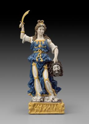 A terracotta sculpture of Judith with a sword in her right hand and the head of Holofernes in her left.