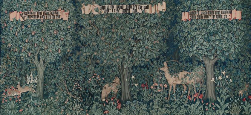 A dark forest scene with two deer standing beneath the verdant leaves of lush trees.