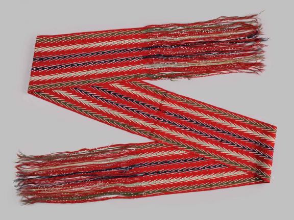 picture of a bright red scarf with tassles