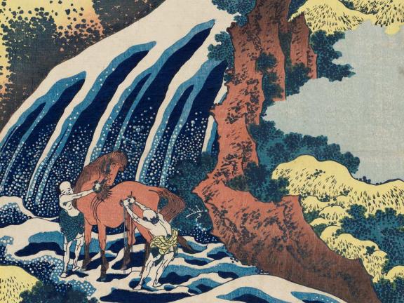 Two men wash a horse downstream in a waterfall.