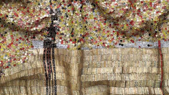 Gold tapestry made from bottle caps and foil