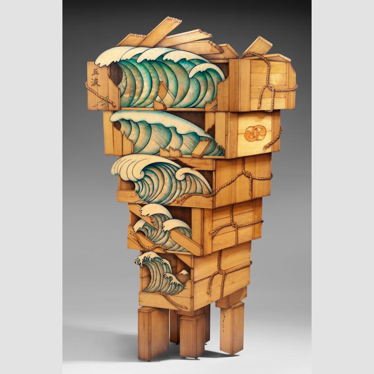 Five stacked wooden boxes with images of waves on the front--the largest one sits on top and each successive one getting progressively smaller.