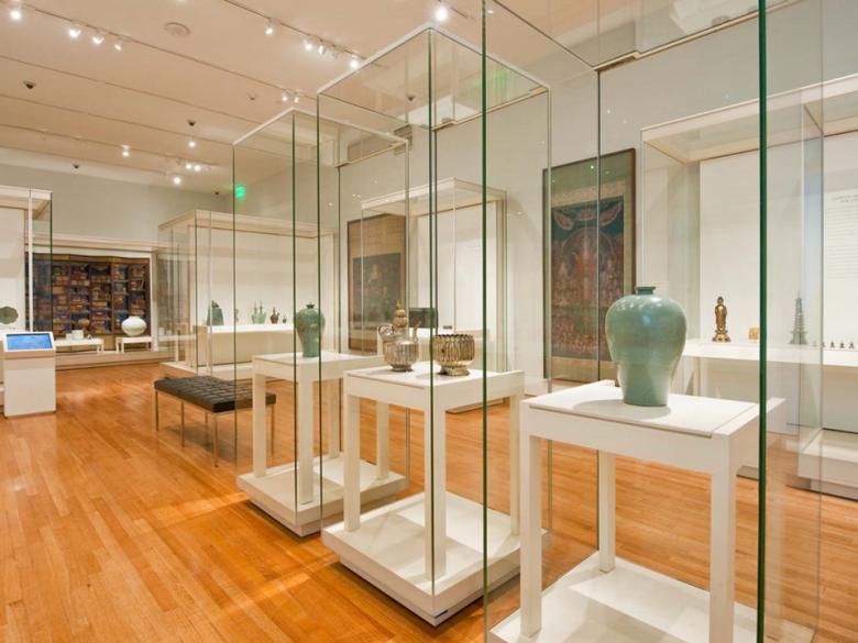 View of Arts of Korea gallery, with several display cases featuring Korean pottery