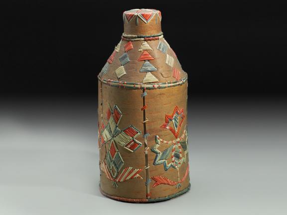 picture of a vessel or bottle with embroidery on the outside