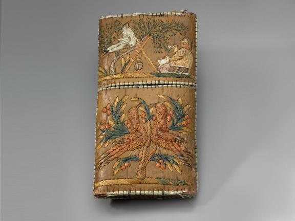 picture of a brown cigar case with embroidery