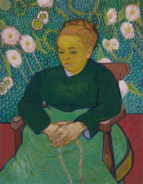 Vincent van Gogh painting featuring woman in green dress and hair in a bun, sitting on chair in front of green wall covered in white flowers