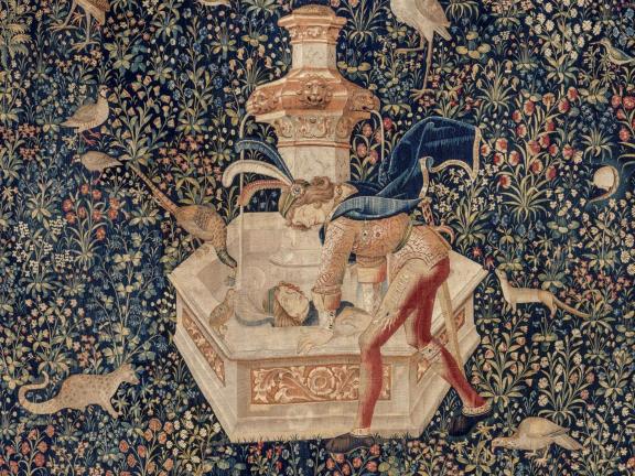 Detail of tapestry depicting Narcissus in feathery headdress and cape looking at reflection fountain; various animals look on