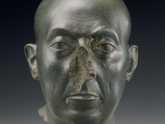 Green colored sculpture of a man's head