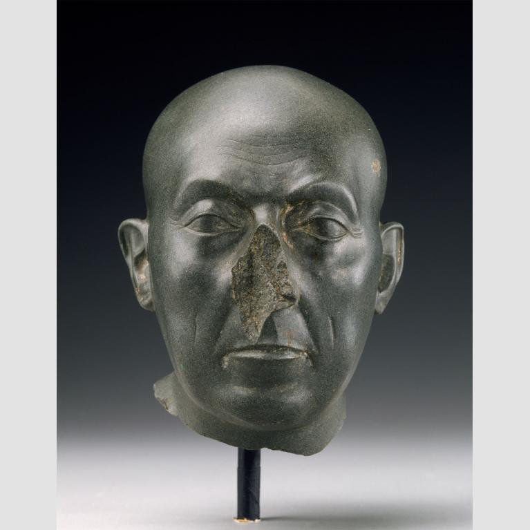 Green colored sculpture of a man's head