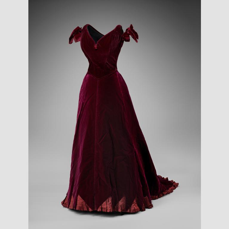A burgundy, silk dress with bowed sleeves. 