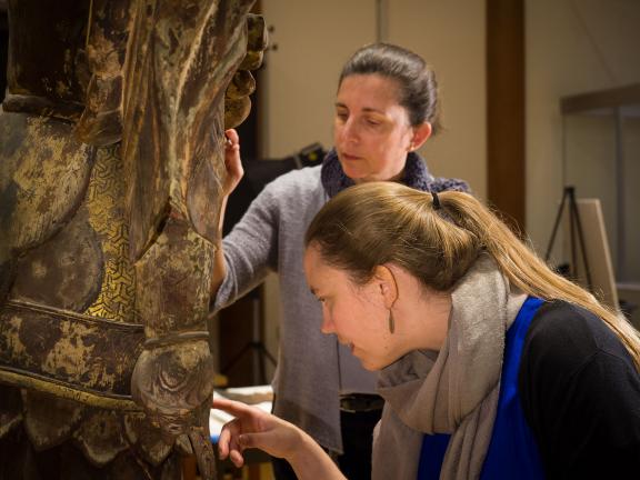 Conservators working on Japanese Buddha sculpture