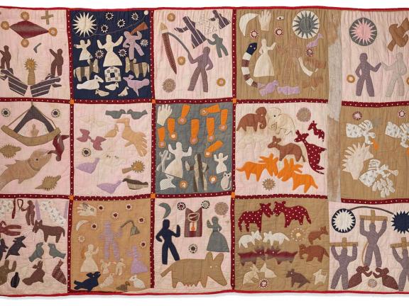 Quilt with different squares depicting human figures and animals