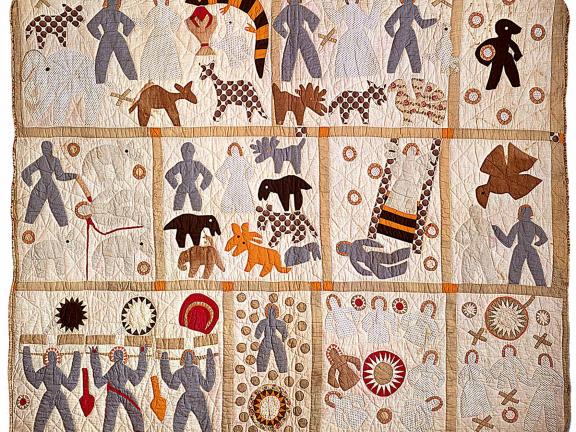 Colorful quilt made of multiple squares with figures and animals.