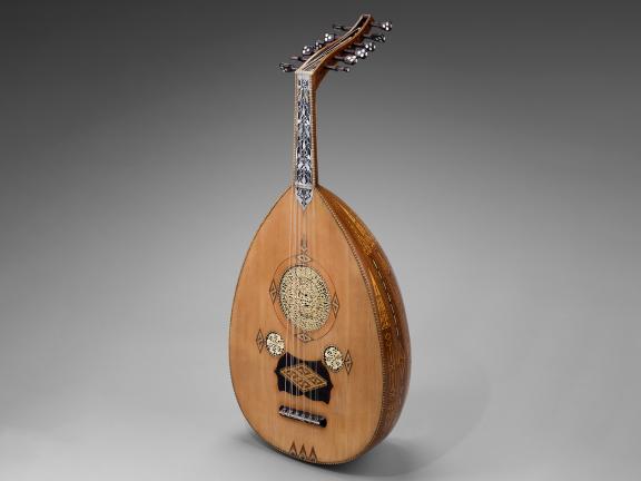 An ornate wood lute inlaid with mother of pearl. 